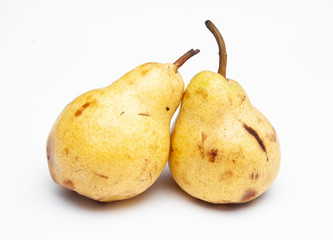 two yellow ripe pears on a white background