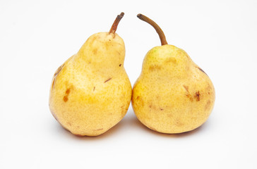 two yellow ripe pears on a white background