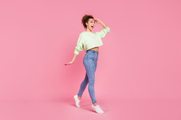 Fototapeta na wymiar Full size profile side photo of astonished positive crazy girl go walk copyspace hold hand see incredible black friday sales impressed wear sweater jumper isolated pastel color background