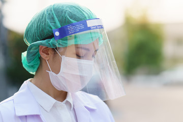 Woman doctor, outdoor portrait, Coronavirus COVID-19 pandemic.