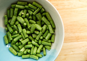 Yardlong bean slice on the plate on the wooden table with top shot