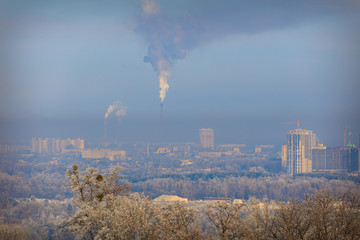 Factories pollute the air. Smog in the city. Frost on the trees. Winter. People are dying of dirty...