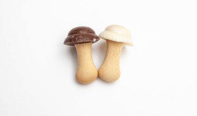 cookies and chocolate in the shape of mushrooms on a white background