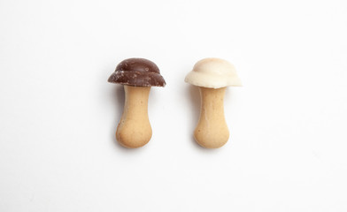 cookies and chocolate in the shape of mushrooms on a white background