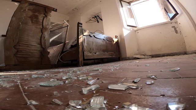 Broken glasses on the floor after a housebreaking in a abandoned apartment. 4k