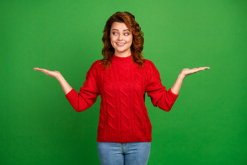 Portrait of positive cheerful girl hold hand display advertisements suggest select promotion wear sweater isolated over bright color background