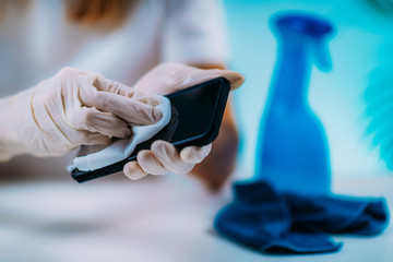 Disinfecting Smart Phone. Woman Disinfecting Smart Phone with Alcohol-Based Disinfectant