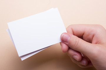 Obraz premium Hand holding business card blank on abstract background