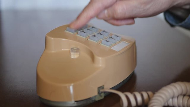 Elderly Man Dialing 911 Number Buttons On Retro Push Dial Telephone. Making Phone Call On Vintage Wired Landline Phone..