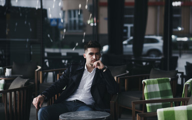 Fototapeta na wymiar Successful business man relaxing in a luxury restaurant outdoors, confident entrepreneur