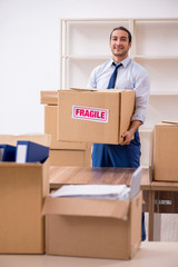 Young male employee in relocation concept