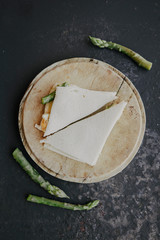 Tasty appetizing toasts with asparagus, eggs, cheese. Soft-boiled egg asparagus sandwich. Tramezzino con uovo e asparagi 