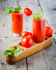 tomato juice and fresh tomato on wooden background