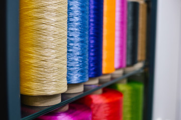 Big colored spool clew of synthetic thread for carpet