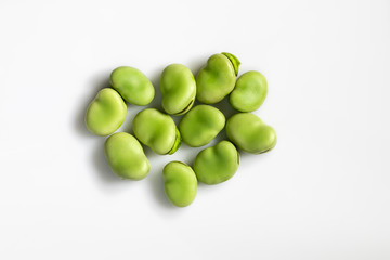 Close-up top view of fresh green broad beans isolated on white background. Healthy food. Macro.
