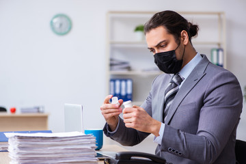 Young male employee in self-quarantine concept