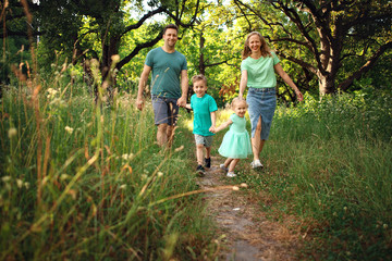 Happy loving family with two children, son and daughter playing and hugging. Family walk. Happy Mothers day.
