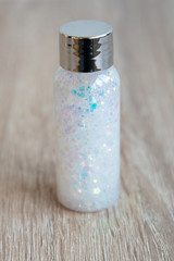 The bottle contains a lot of sequins of different colors. The concept of magic and celebration.