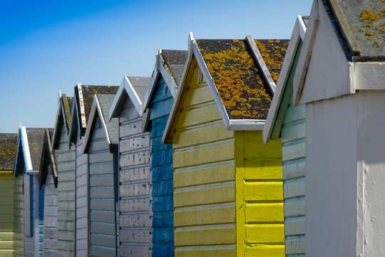 Colourful painted beach huts on Lancing Beach, West Sussex, England, United Kingdom in sunset.