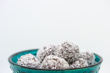 Close up of coconut balls in a turquoise bowl