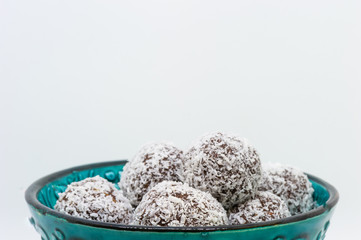 Close up of coconut balls in a turquoise bowl