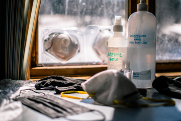 COVID-19 Survival kit in the medicine cabinet. Be protected during the coronavirus pandemic, alcohol, hand sanitizers, cloth gloves, latex gloves, surgical masks, N95 masks, 70% alcohol spray 