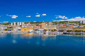 Croatia, city of Rijeka, aerial panoramic view of city center, marina and harbor from drone, reflection in sea
