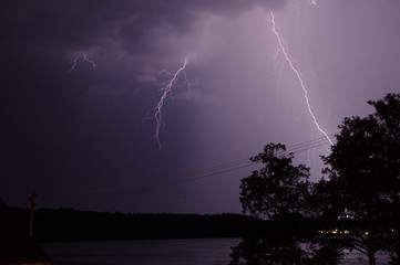 Naklejka na ściany i meble Thunderstorm night on the lake