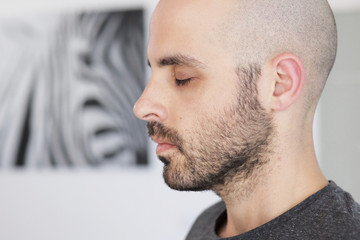 Caucasian man is meditating at home