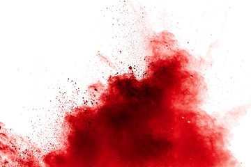 Red powder explosion on white background. Freeze motion of red dust particles splash.