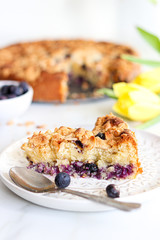 Coffee Cake with blueberries and almonds. Morning scenery with tulips. 