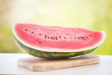 Fresh watermelon slice on blue wooden  background. Summer background