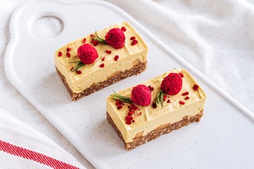 Mango cake. Freeze-dried raspberries and nuts. Raw dessert. Vegetarian healthy food	
