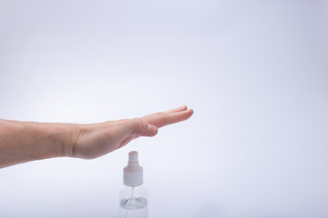 hand and bottle of antiseptic protection against the virus