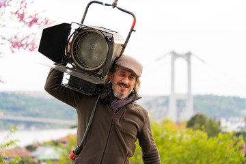 Film's worker with big fresnel lights. The Lighting Designer