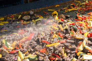 Fototapeta na wymiar The process of preparing a quesadilla, traditional Mexican dish. Outdoor outside setting