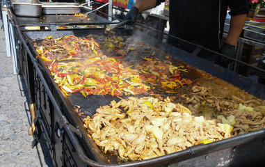 The process of preparing a quesadilla, traditional Mexican dish. Outdoor outside setting