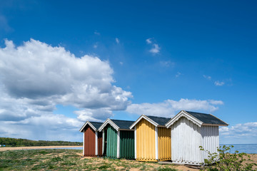 Fototapeta na wymiar Colourful beach huts in a row on the beach in Simrishamn, Skane, Sweden