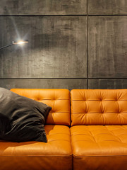 orange loft sofa with a light lamp in the room
