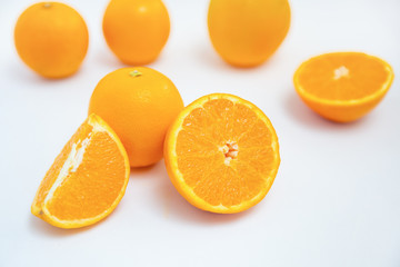 Group of juicy oranges isolated on white background. Studio shot. Selective focus. Close-up side view. Citrus fruit and healthy food concept