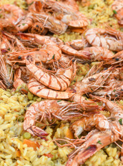 Seafood paella cooked in a large pan wok, street food festival. Mexican fiesta national day