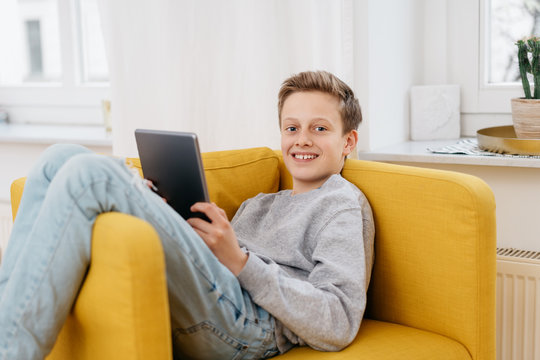 Happy friendly young boy relaxing at home