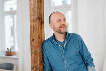 Middle-aged man standing watching quietly