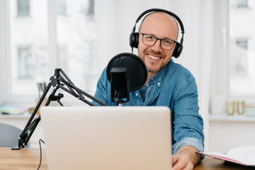 Happy friendly man recording a podcast