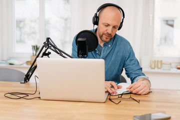 Middle-aged man working on recording a podcast