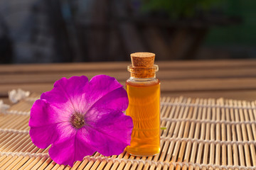 petunia essential oil in  beautiful bottle on table