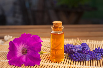 Fototapeta na wymiar Essential oil of muscari flower on a table in beautiful bottle