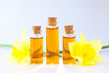 Essence of flowers  on white in beautiful glass jar