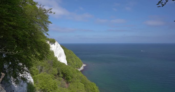 King's Chair in the Jasmund National Park on the Baltic Sea island of R&uuml;gen, the best-known white chalk cliff on a sunny day with clear blue sky with small clouds and a green forrest