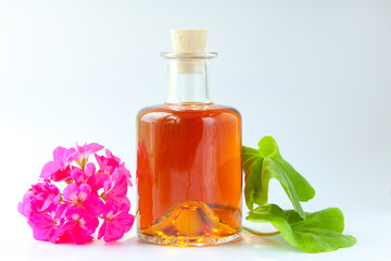 Essence of flowers on table in beautiful glass jar